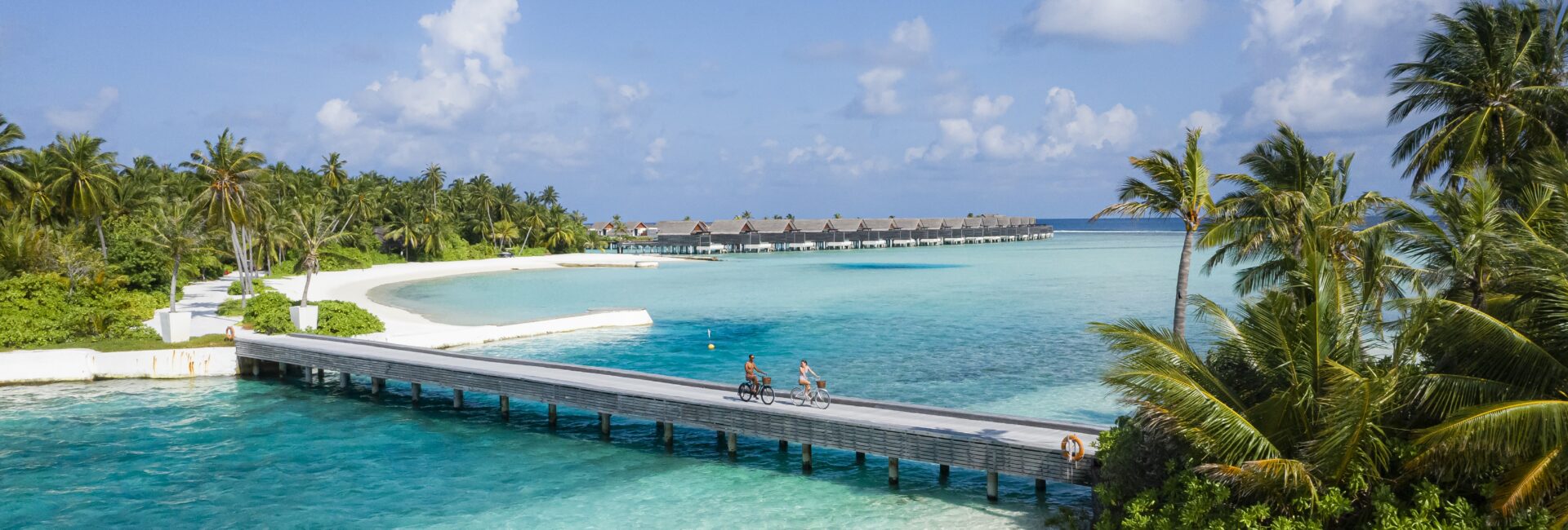 Niyama Private Islands - Bridge with couple cycling